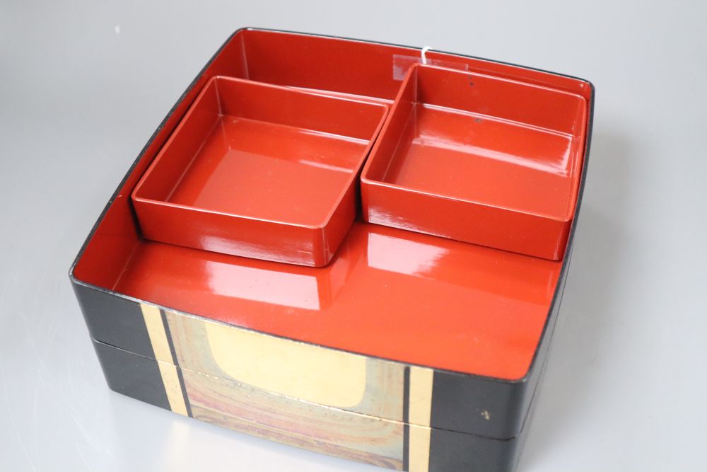 A 20th century Japanese lacquer picnic box and a Belemnite dish